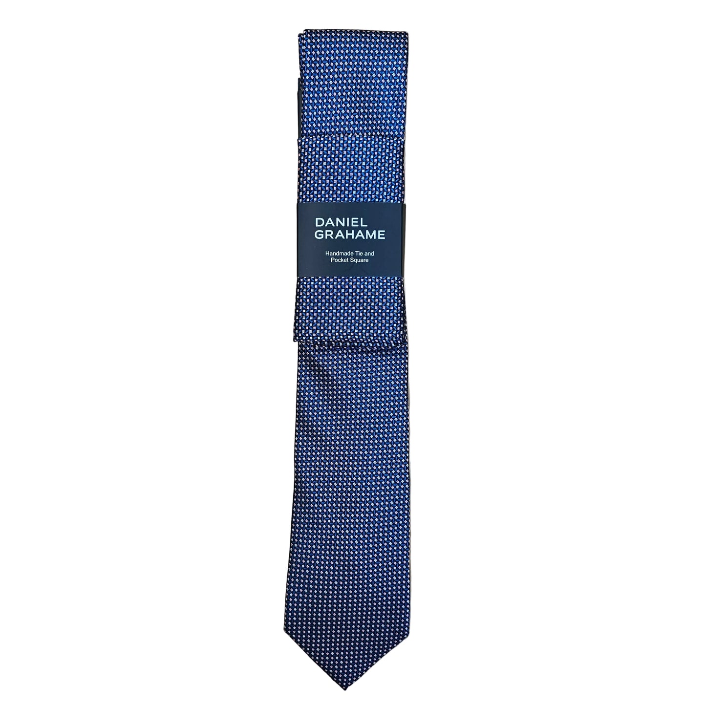 A navy blue patterned necktie with a black paper band label reading 'DANIEL GRAHAME', laid flat on a light wood grain surface.
