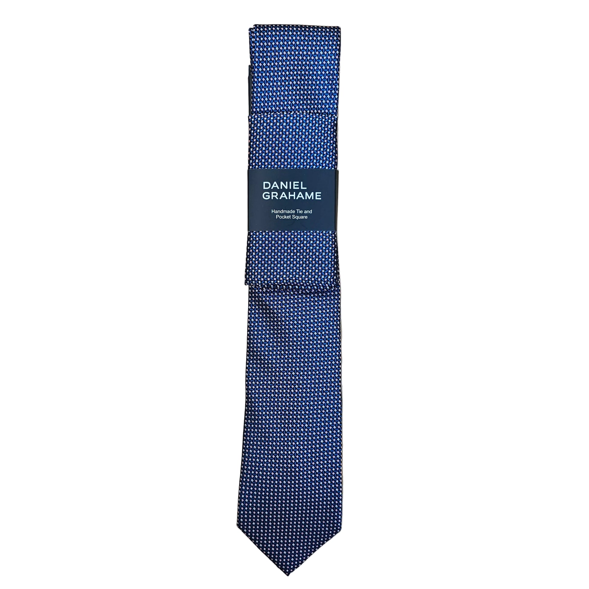 A navy blue patterned necktie with a black paper band label reading 'DANIEL GRAHAME', laid flat on a light wood grain surface.