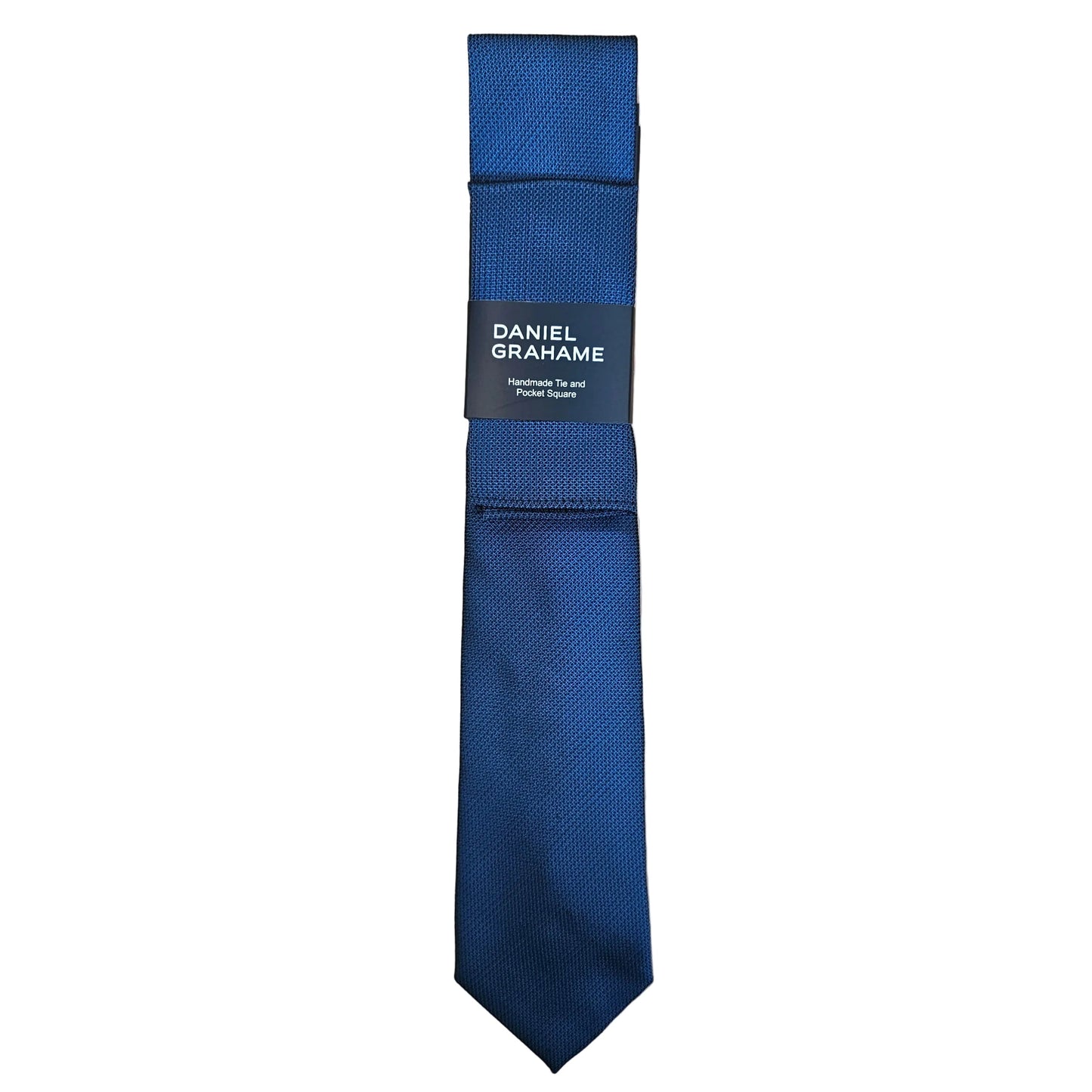 A blue textured necktie with a dark gray paper label that reads 'DANIEL GRAHAME' in white text, displayed vertically against a plain white background.
