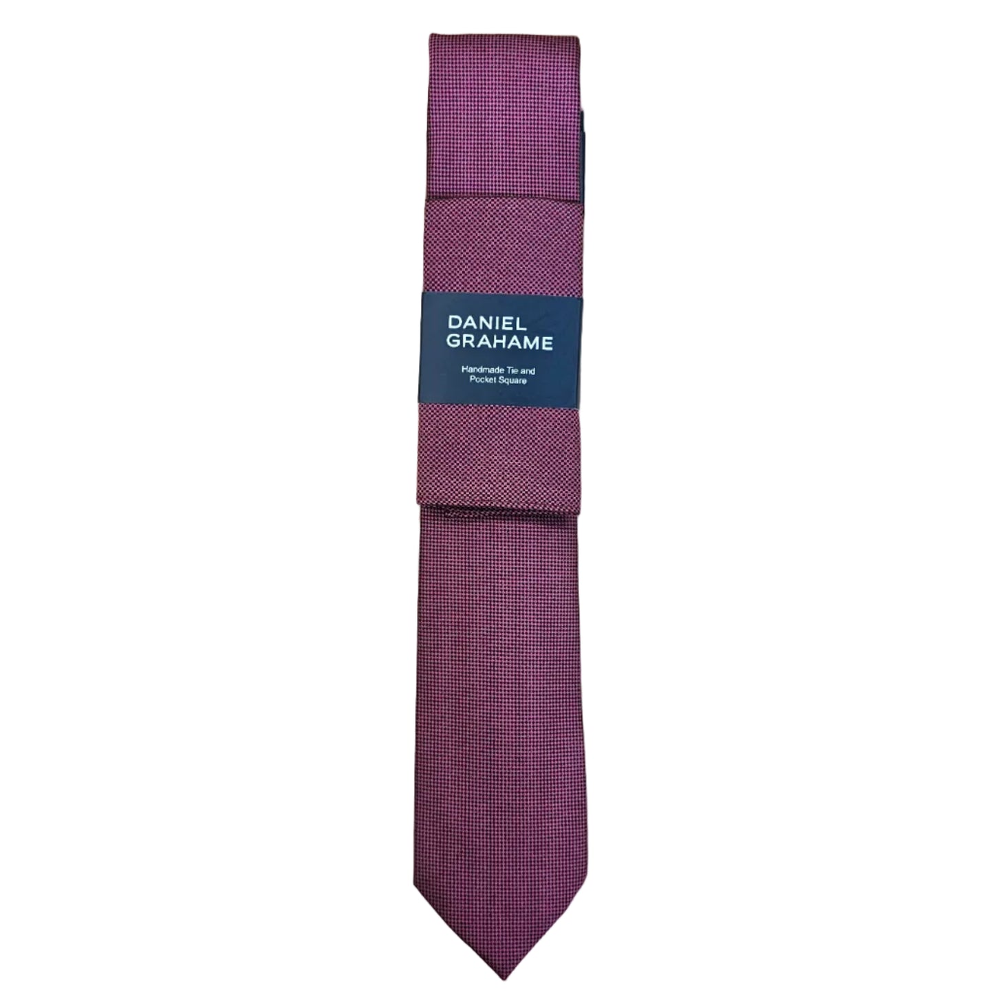 A folded red necktie with a dark blue paper band label that reads 'DANIEL GRAHAME', placed on a white surface.