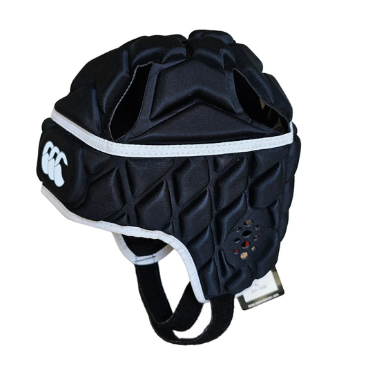 A black rugby helmet protector with white trim and a white Canterbury logo, displayed on a light wood floor.
