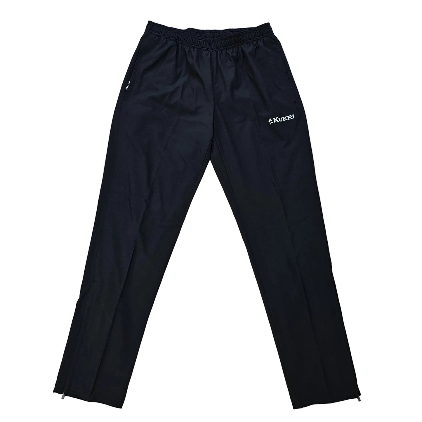 Black athletic pants laid flat on a light wood floor, featuring a small white logo on the upper left thigh.